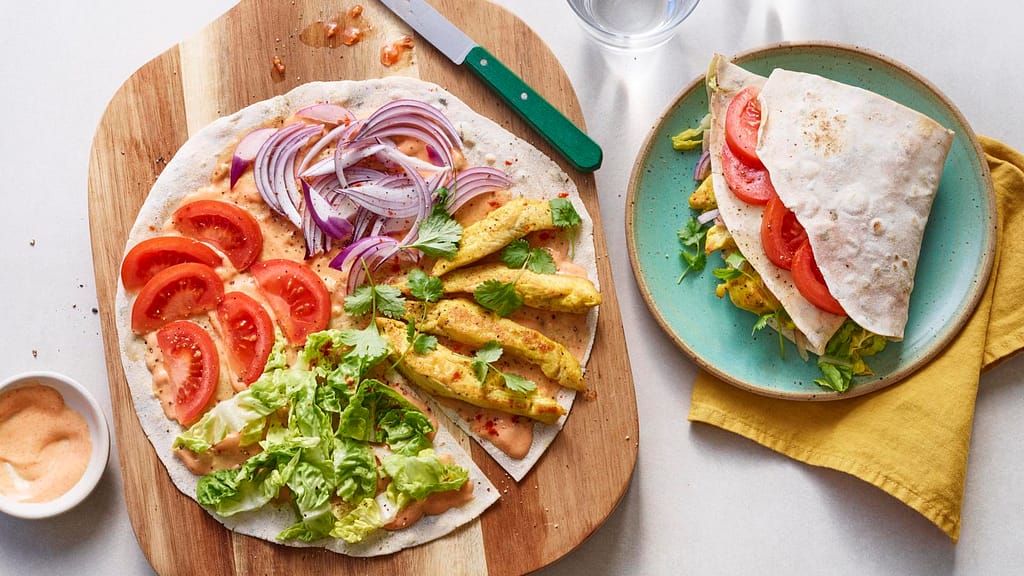 Grilled chicken wraps with fresh vegetables and a sauce